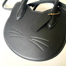 Load image into Gallery viewer, Black cat-shaped handbag with a tag on a white background