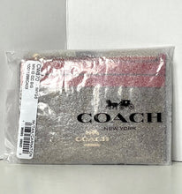 Load image into Gallery viewer, Coach wallet in packaging with visible branding on a gray background