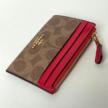 Load image into Gallery viewer, Brown wallet with red zipper on a light gray background