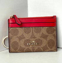 Load image into Gallery viewer, Coach wallet with red top section and brown bottom section on a white background