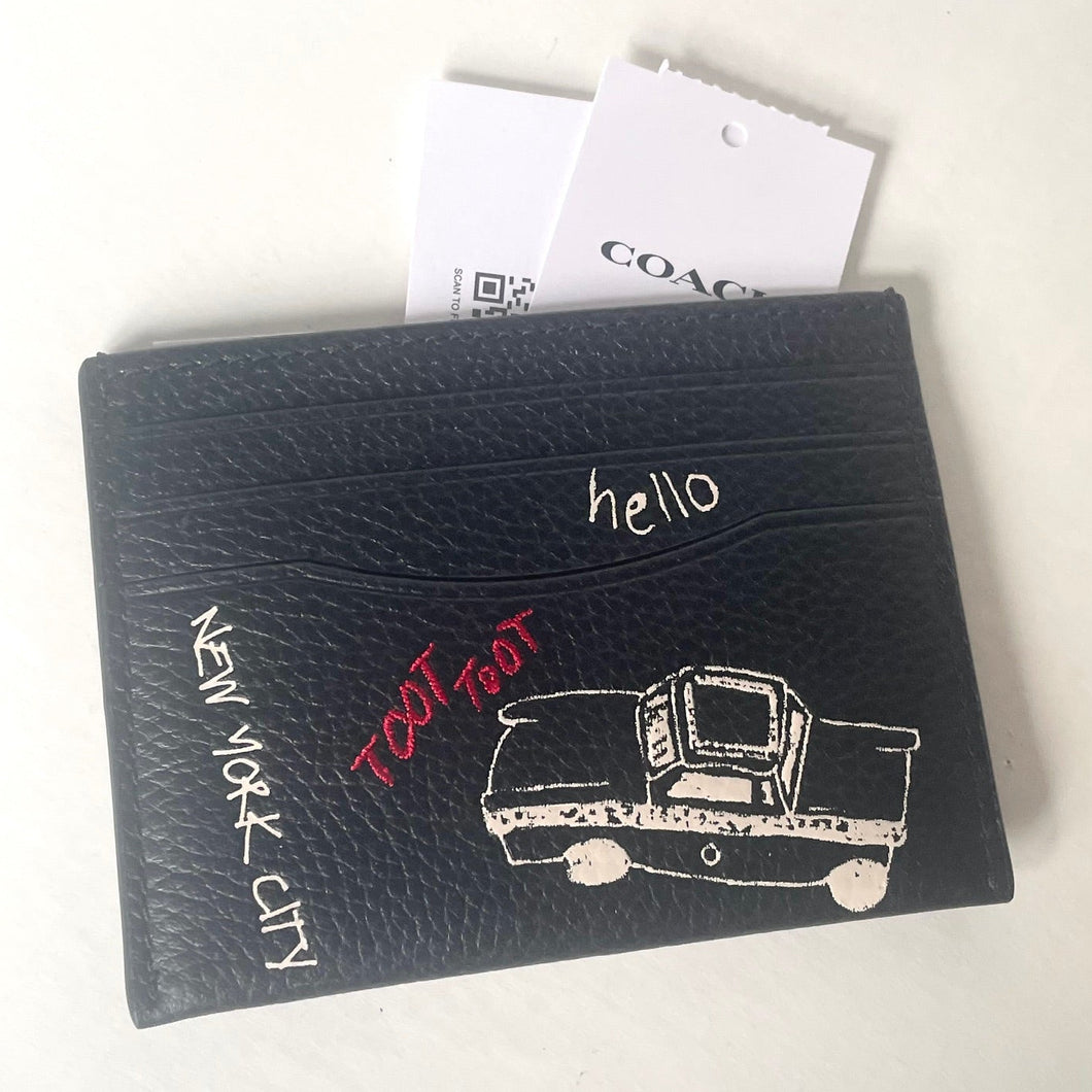 Black cardholder with 'New York City' and 'hello' text, featuring a taxi illustration, on a white background.