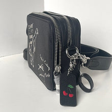 Load image into Gallery viewer, Black crossbody bag with cherry design and keychain on a white background