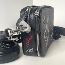 Load image into Gallery viewer, Black leather handbag with zippers and branding on a white background