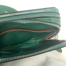 Load image into Gallery viewer, Green zipper pouch with visible brand name on a white background