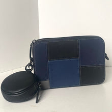 Load image into Gallery viewer, Blue and black patchwork pouch with a round black case on a white background
