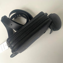 Load image into Gallery viewer, Black leather bag with multiple zippers on a light gray background