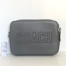 Load image into Gallery viewer, Gray Coach handbag with a visible brand tag on a white background