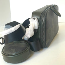 Load image into Gallery viewer, Black travel case with a compartment containing white plastic bags on a white background