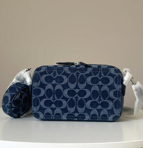Navy blue cosmetic bag with brand logo on a white background