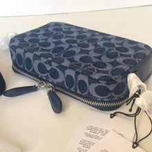 Load image into Gallery viewer, Blue patterned clutch bag with a tag on a white surface