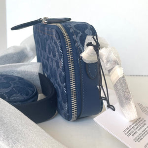 Blue textured pouch with a zipper on a white surface