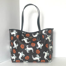 Load image into Gallery viewer, Tote bag with Halloween-themed design featuring ghosts and pumpkins on a black background.