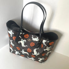 Load image into Gallery viewer, Black handbag with Halloween-themed pattern on a white background