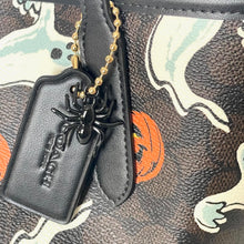 Load image into Gallery viewer, Black spider charm on a Coach bag with Halloween design