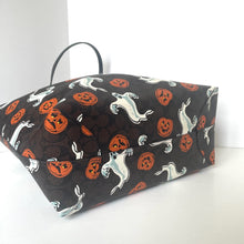 Load image into Gallery viewer, Dog bed with Halloween-themed pattern featuring dogs and pumpkins on a black background.