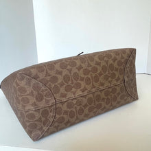 Load image into Gallery viewer, Brown patterned clutch bag on a white background