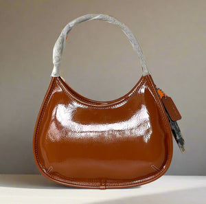Brown handbag with a gray handle on a white background