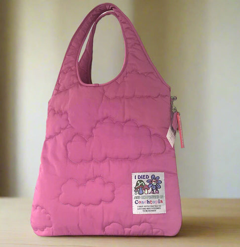 Pink quilted bag with a visible brand label on a white background