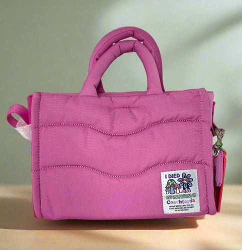 Pink handbag with a label on a white background