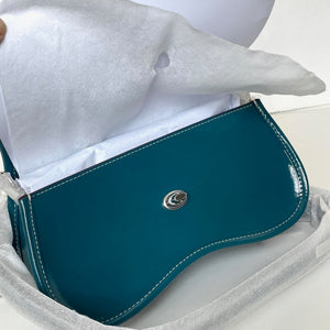 Teal saddle pad with a brand logo on a white background