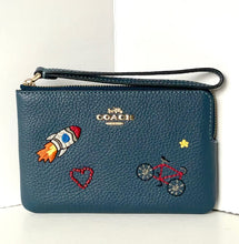 Load image into Gallery viewer, Blue Coach wallet with embroidered designs on a white background