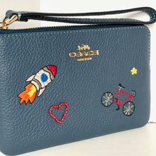 Load image into Gallery viewer, Blue Coach wallet with embroidered designs on a white background