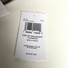 Load image into Gallery viewer, Clothing tag with barcode and text on a white background
