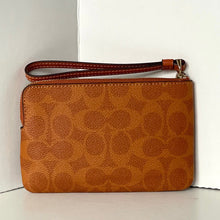 Load image into Gallery viewer, Brown leather clutch with visible brand logo on a white background