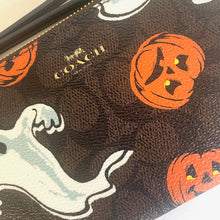 Load image into Gallery viewer, Coach wallet with Halloween-themed design featuring pumpkins and ghosts.