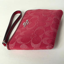 Load image into Gallery viewer, Red wristlet with Coach logo on a light background