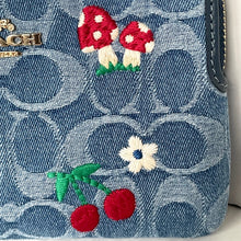 Load image into Gallery viewer, Denim bag with embroidered red mushrooms, white flower, and red cherries on a white background