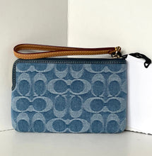 Load image into Gallery viewer, Blue denim-patterned clutch with brown wrist strap on a white background