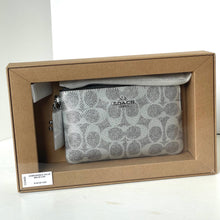 Load image into Gallery viewer, Coach pouch in a brown box on a white background