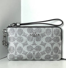 Load image into Gallery viewer, Coach wristlet with silver pattern on a white background