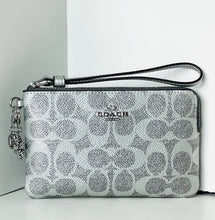 Load image into Gallery viewer, Coach wristlet with silver logo on a white background