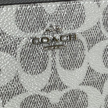 Load image into Gallery viewer, Coach logo on a patterned surface