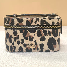 Load image into Gallery viewer, Leopard print Coach bag on a textured surface with a beige background