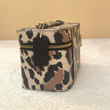 Load image into Gallery viewer, Leopard print makeup bag with gold zipper on a textured surface