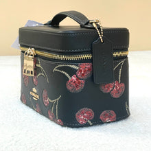 Load image into Gallery viewer, Black cosmetic bag with floral pattern and gold accents on a white surface.