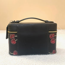 Load image into Gallery viewer, Black jewelry box with red floral patterns on a beige background