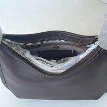 Load image into Gallery viewer, Open dark gray handbag with a phone inside on a light background