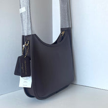 Load image into Gallery viewer, Brown handbag with a visible brand tag on a white background