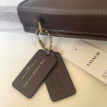 Load image into Gallery viewer, Coach bag with two brown tags and a visible tag on a light background