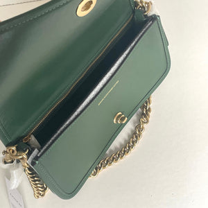 Green handbag with gold chain strap on a white background