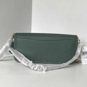 Green handbag with a gray strap on a white background