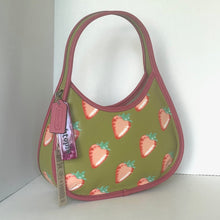 Load image into Gallery viewer, Green handbag with strawberry pattern and Coach tag on a white background