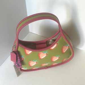 coach ergo Handbag with strawberry pattern on a white background