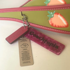 coach ergo Pink Coachtopia pouch with strawberry design on a white background
