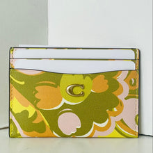 Load image into Gallery viewer, Floral patterned cardholder with a visible brand logo on a white background