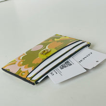 Load image into Gallery viewer, Floral patterned cardholder with a visible brand tag on a light gray background
